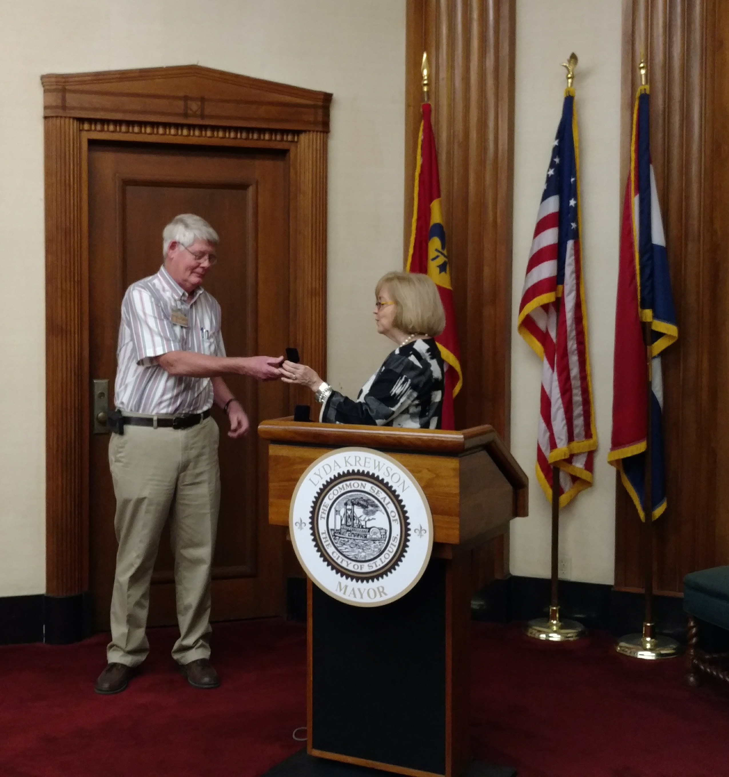 Tom Huelman receives his 40-year service pin from Mayor Lyda Krewson