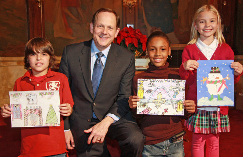 Mayor Francis G. Slay poses with the top three finalists in his 2010 Holiday Card Design Contest.