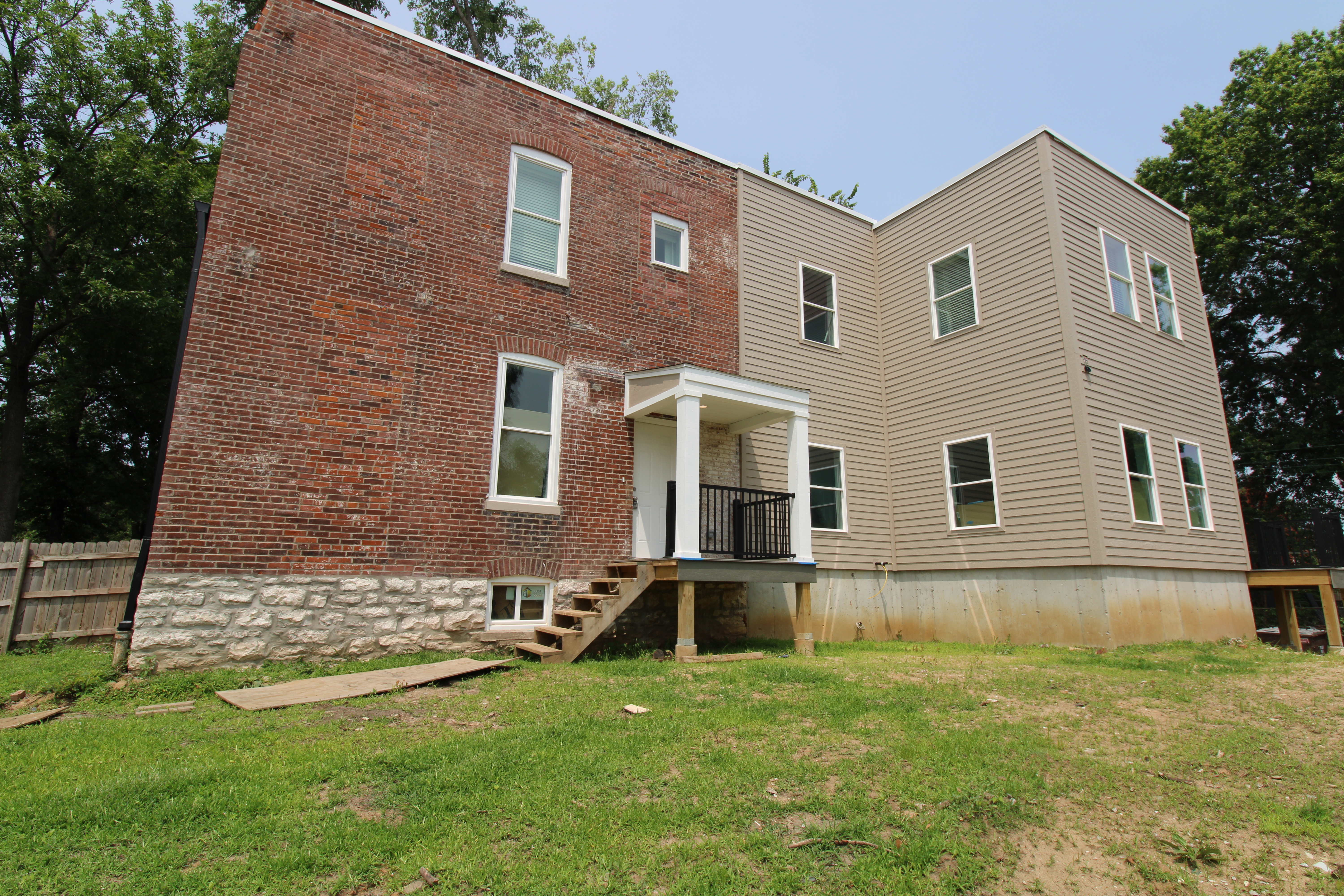 Former vacant house now nearly totally rehabbed with an addition. Brick and wood exertior. 