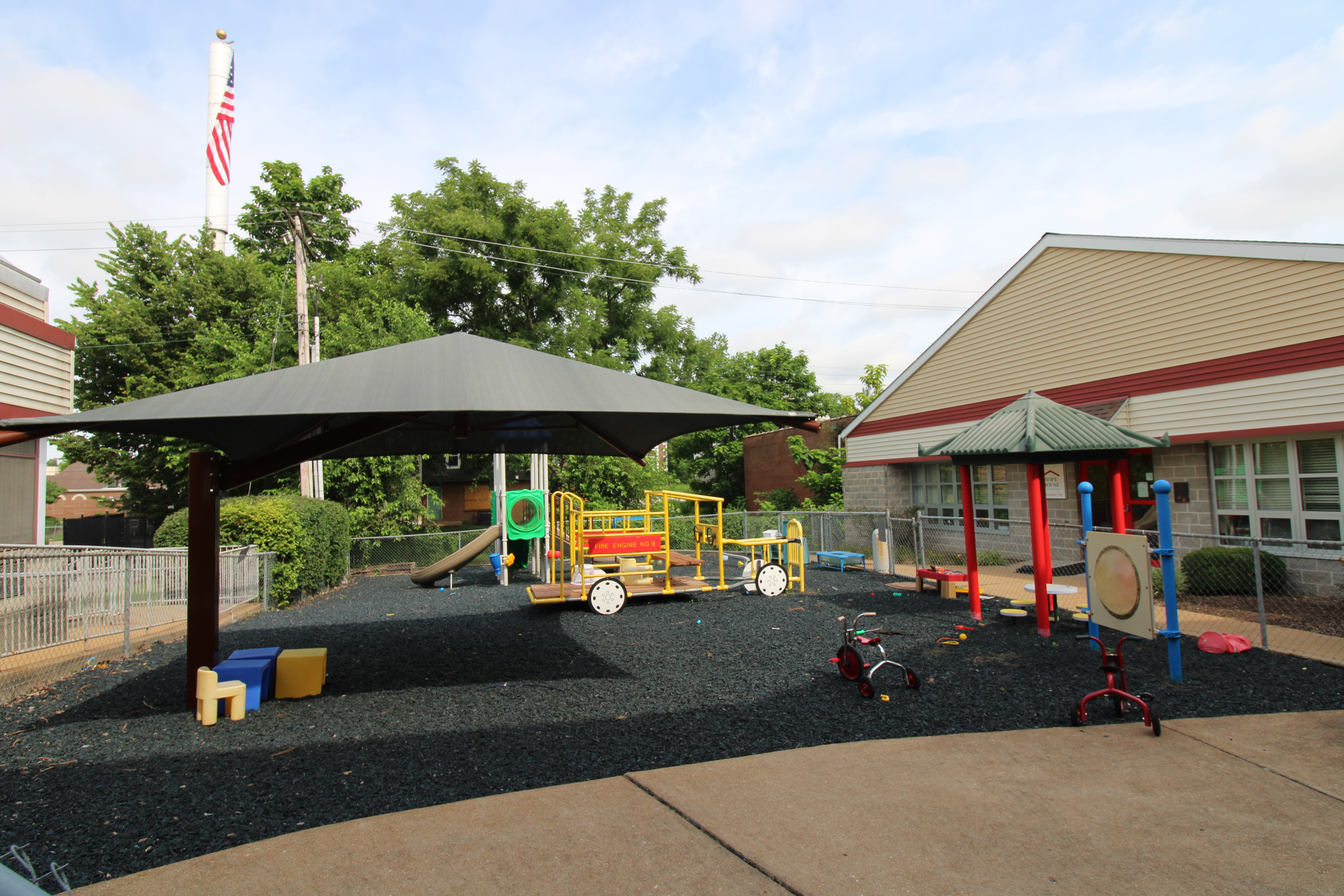 Outside of the Child Development Center, featuring a playground and shade area.