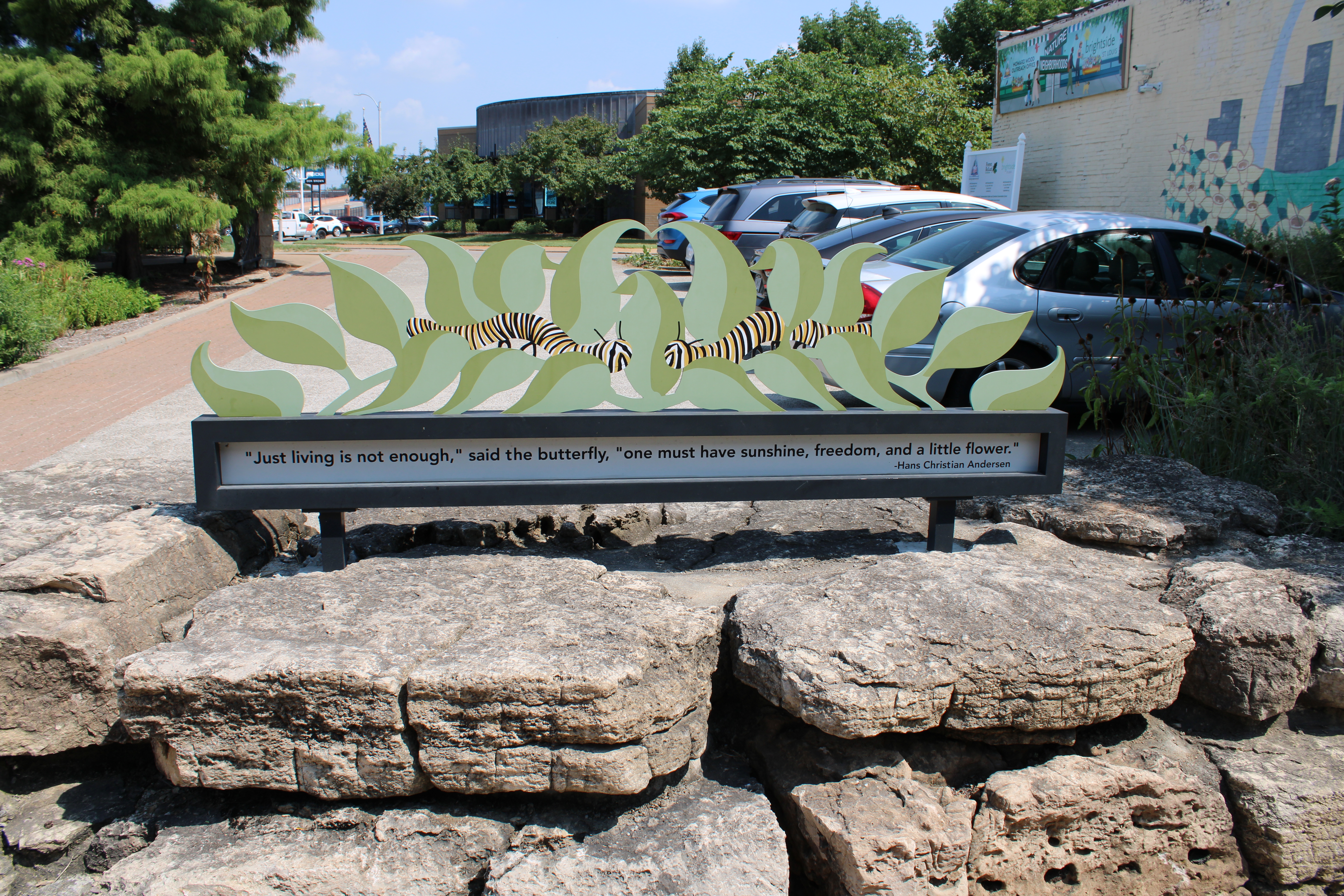 Photo of the back of their Cornelsen Conservation Center sign that reads “Just living is not enough,” said the butterfly, “one must have sunshine, freedom, and a little flower.”– Hans Christian Andersen