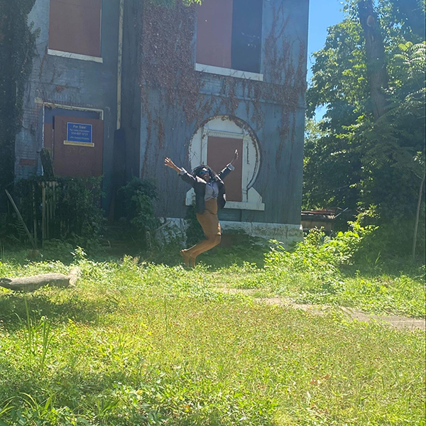 Monique Thomas, Executive Director of Cornerstone Corporation, celebrates in front of 5908 Etzel the day it was acquired from the City’s LRA. The property will be developed into a community hub resident of the West End and adjacent neighborhoods.