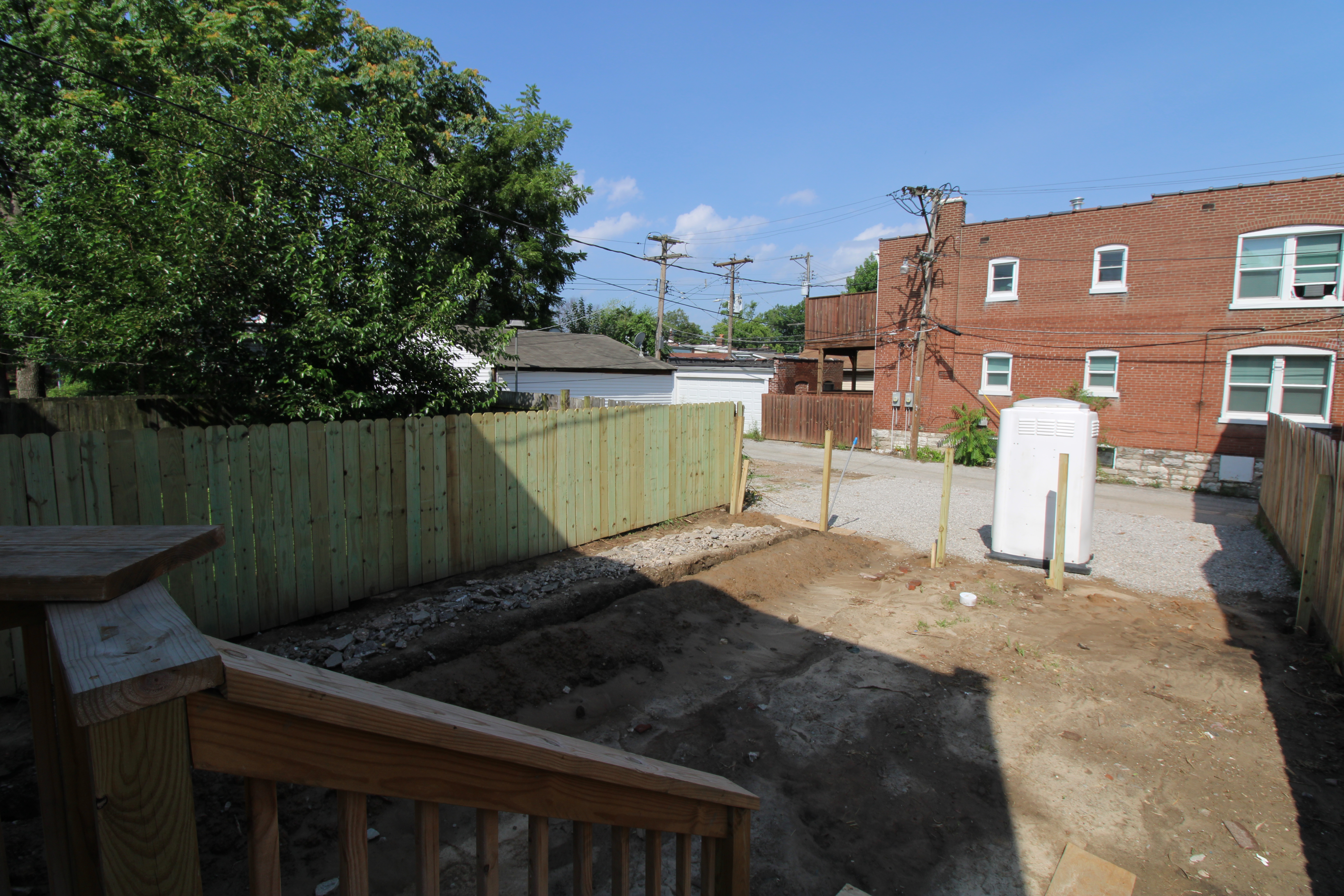 Back view of SJHI’s latest project on Virginia Avenue where volunteer fence construction is underway.
