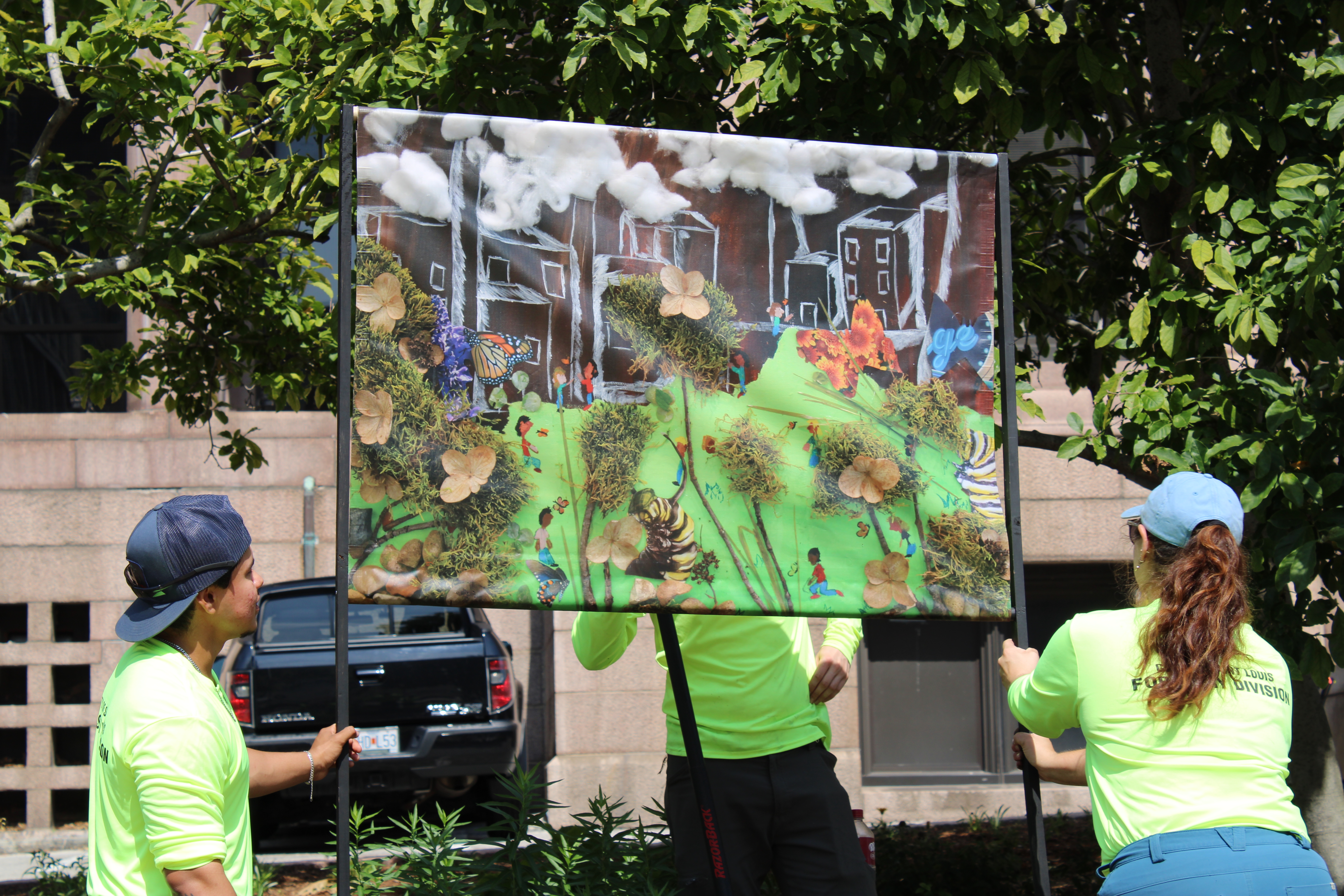 “Where Monarchs Reclaim the City” mural being put up by Forestry Department Employees