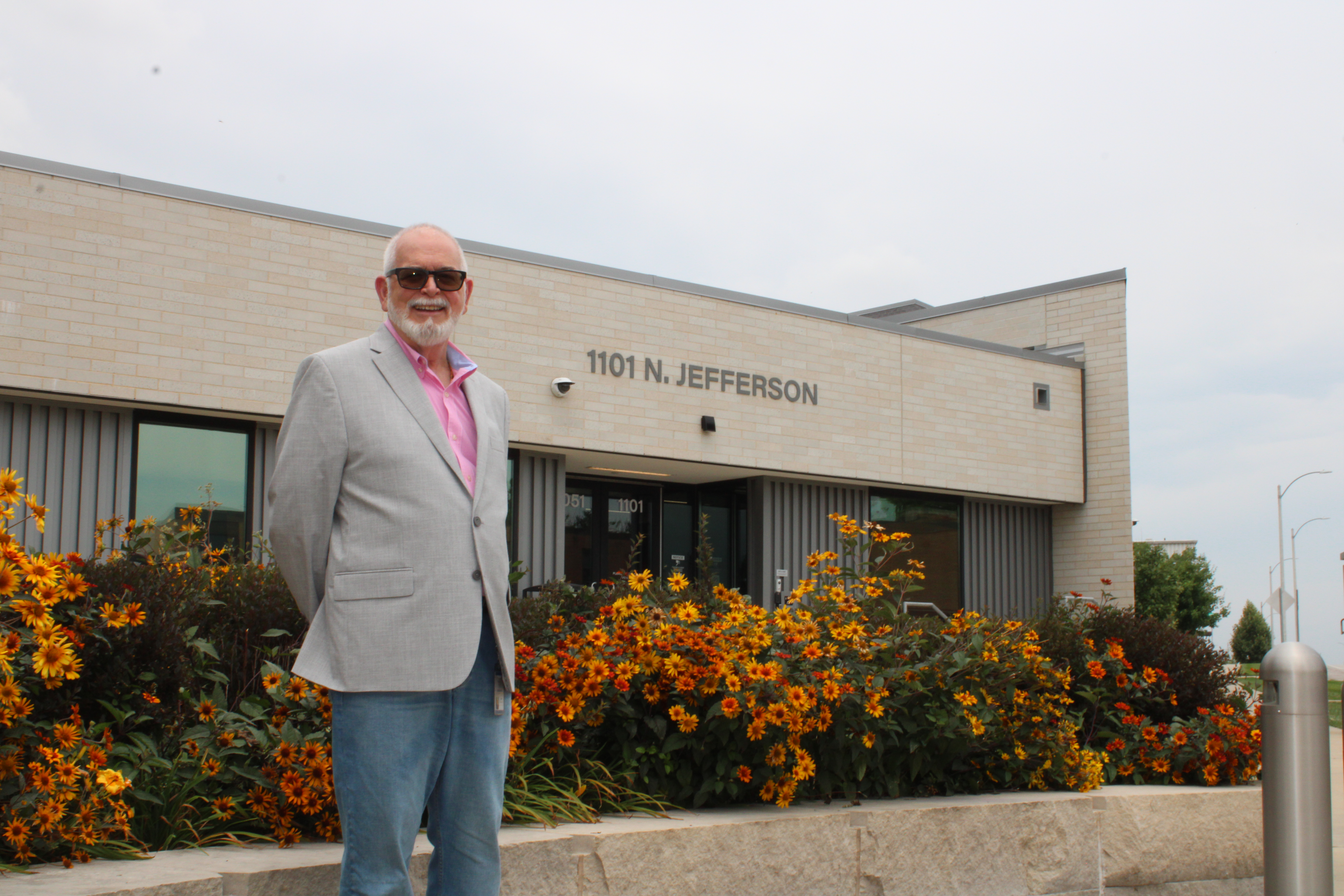 Jim Timmerberg, standing in front of the main building on the Jefferson Avenue Campus