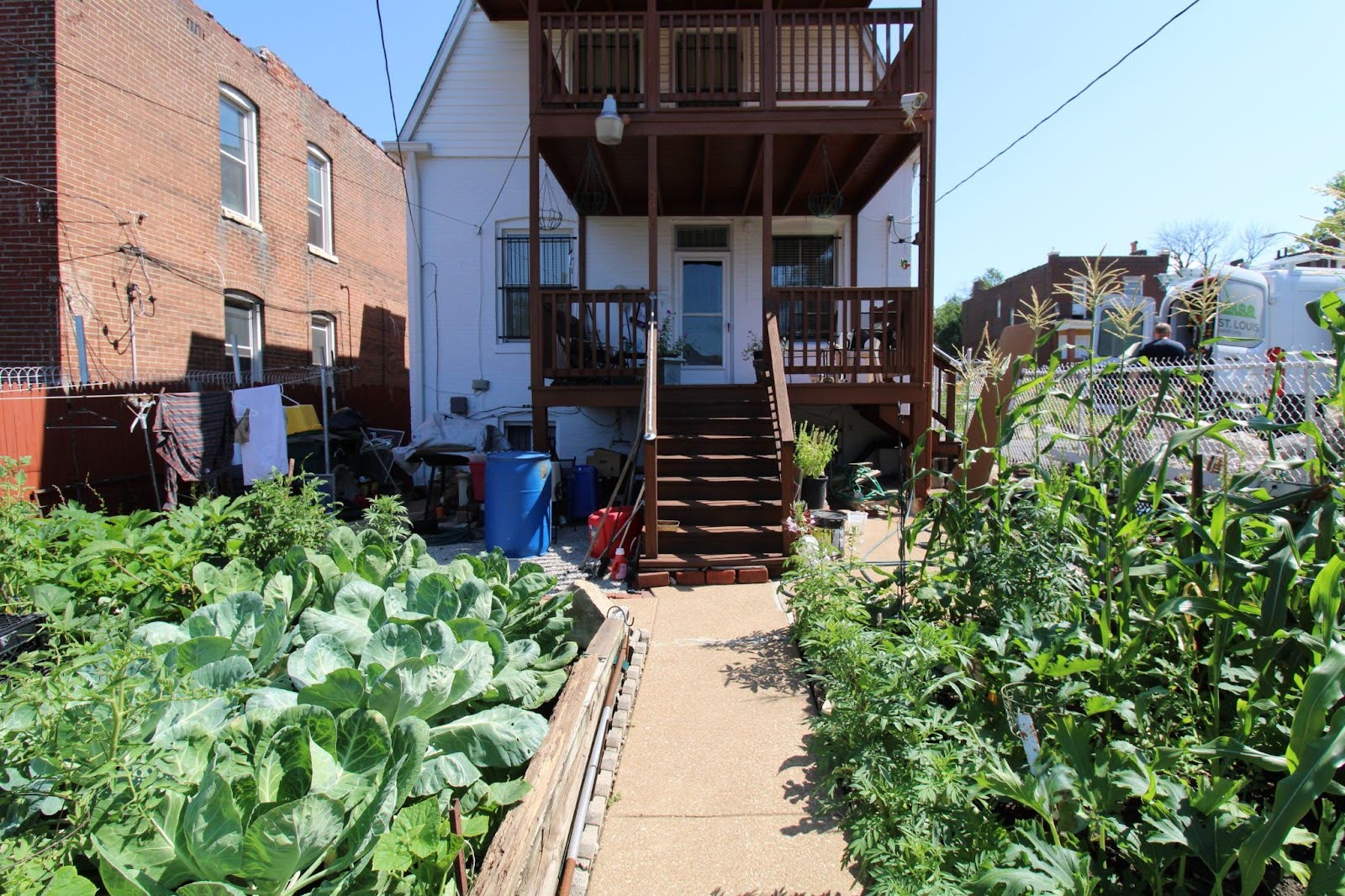 Back view of Ms. Bobbie’s home, where a newly installed grab bar provides easier access to and from her harvest ready garden.