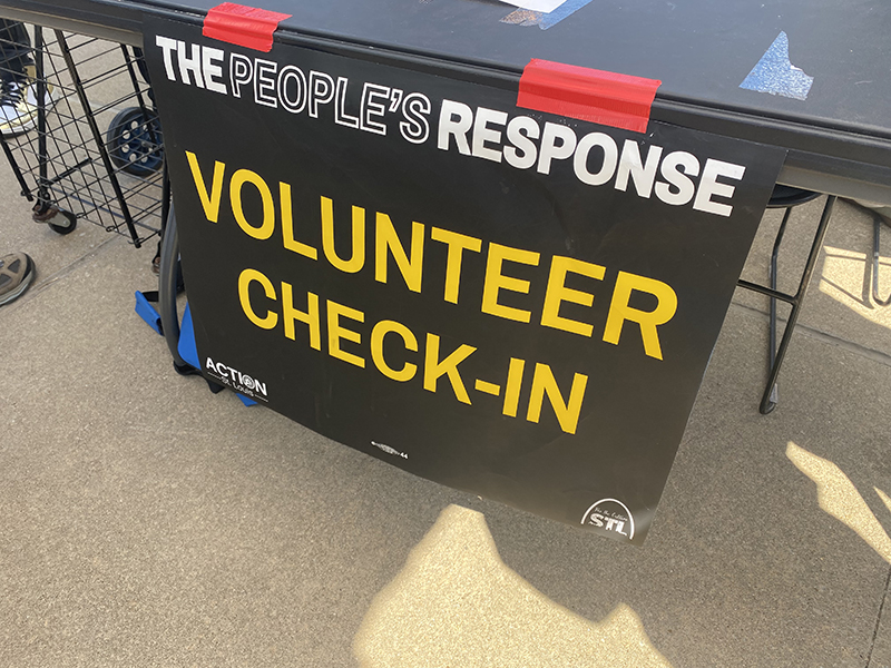 The "People's Response" volunteer sign on a table