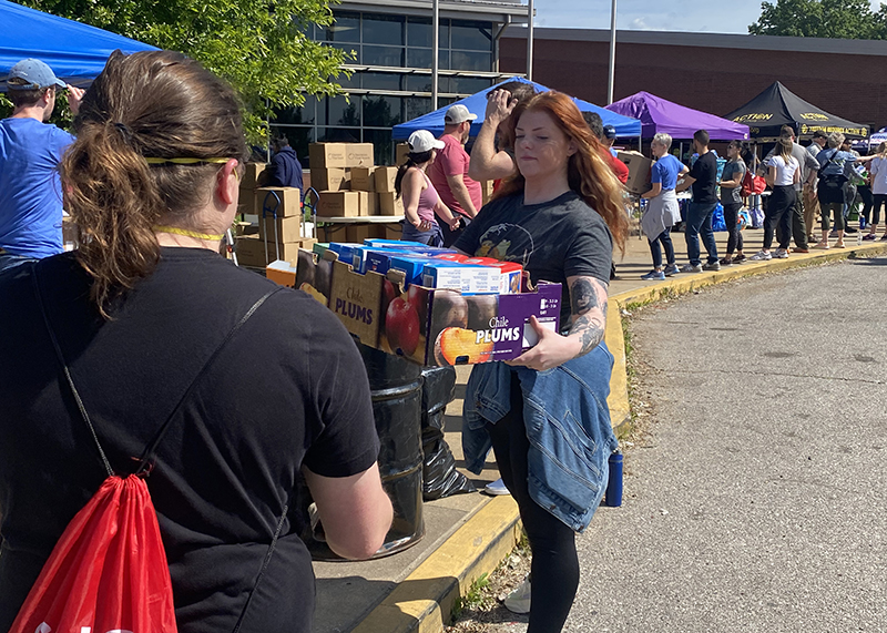 Volunteers distributing items in a line