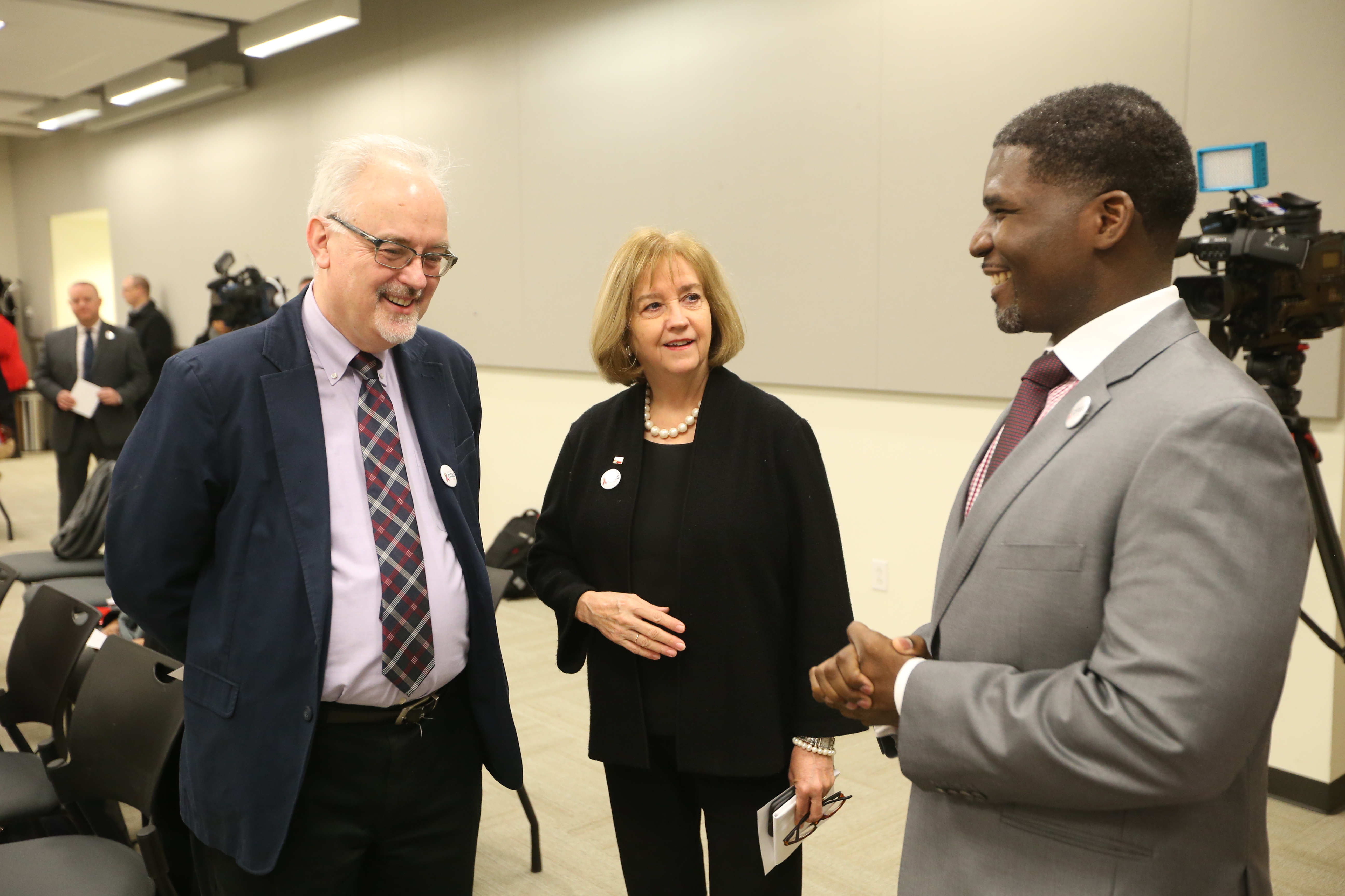 Mayor Lyda Krewson, Director of Health Fredrick Echols, and IAPAC CEO Jose Zuniga prepare for the signing ceremony.