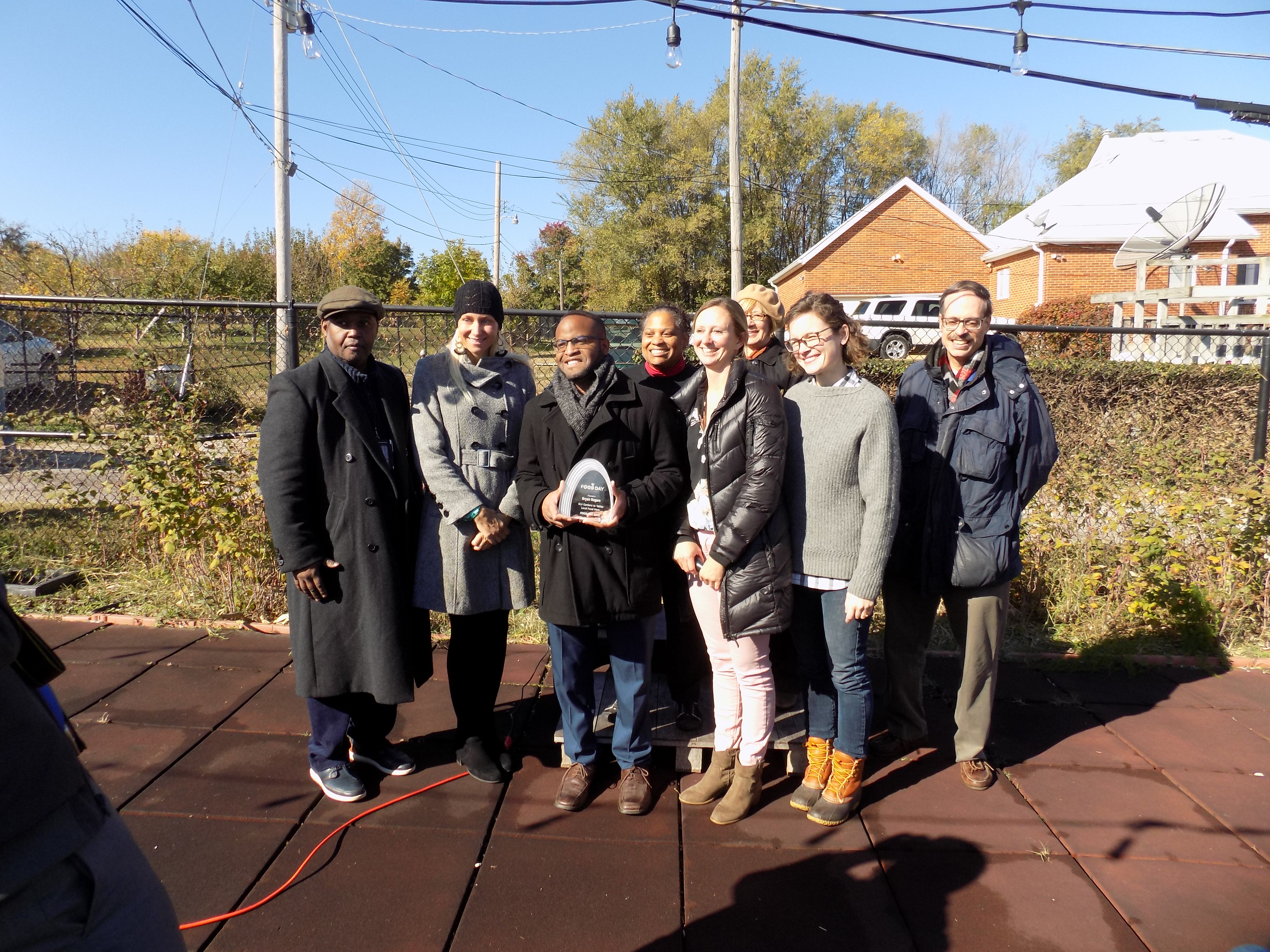 Staff from the Department of Health and St. Louis University gather with Bryan Rogers for a group photo.