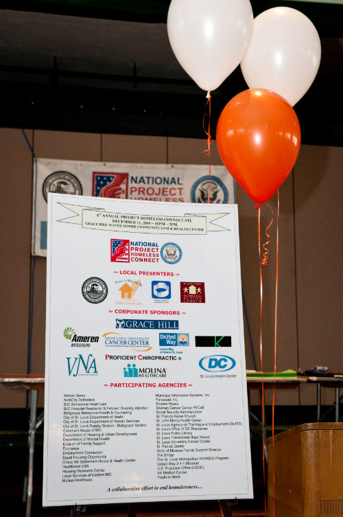 2010 Project Homeless Connect sign and balloons at event.