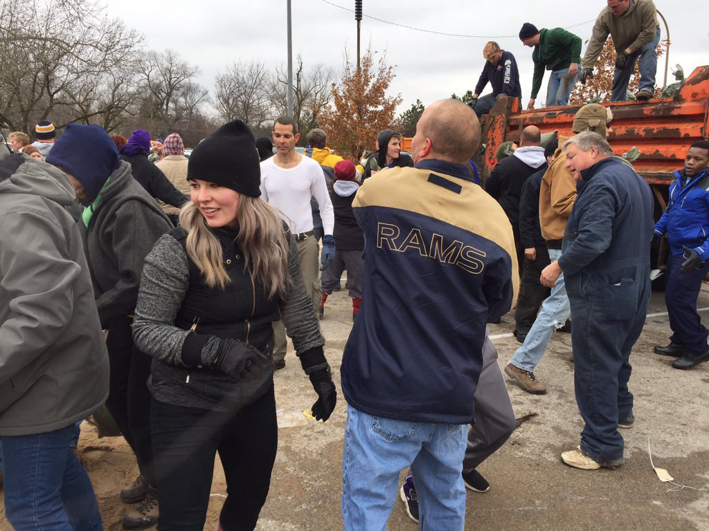 Volunteers fill sandbags