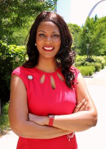 Mayor Tishaura O. Jones in Red Outfit at City Garden with Gateway Arch in the background