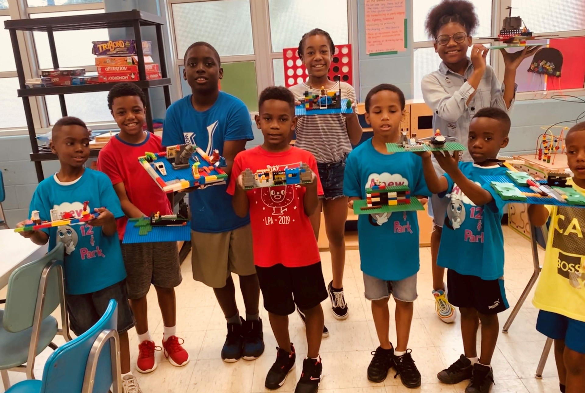 Kids displaying their completed lego models