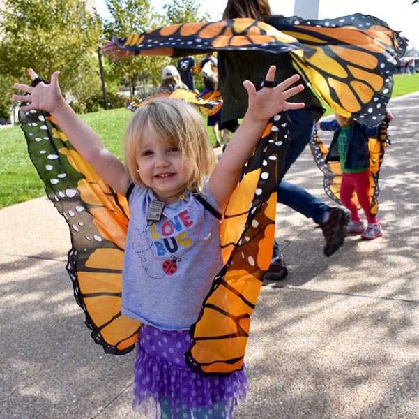 young Girl wearing monarch Butterfly wings