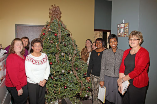 COR employees and contest judges pose by the Chocolate Splendor entry in the 2012 Tree Decorating Contest.