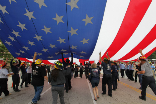 Firefighters work to raise the Flag