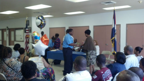 Corrections Training Coordinator Kathryn Wright presents each graduate with a certificate of achievement.