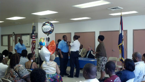 Major Tonya Harry pins on the badges of the new officers.