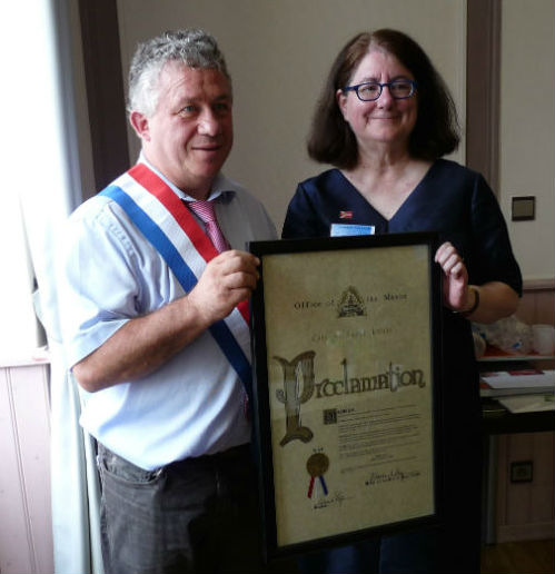 Bedous Mayor Henri Bellegarde receives the proclamation presented by Karen Goering on behalf of Mayor Francis Slay.