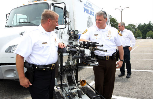 Police Chiefs Sam Dotson and Tim Fitch look over a piece of equipment the Bomb and Arson Units use