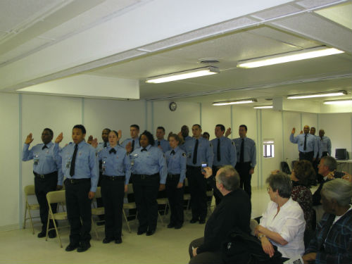 Family members and friends watch the swearing in of the new Correctional Officers