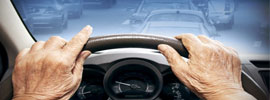 Elderly hands on steering wheel