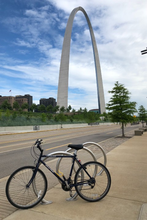 Bicycle by bike rack and Gateway Arch in the Background