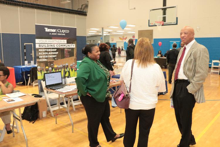 Otis Williams speaking with fair attendees.