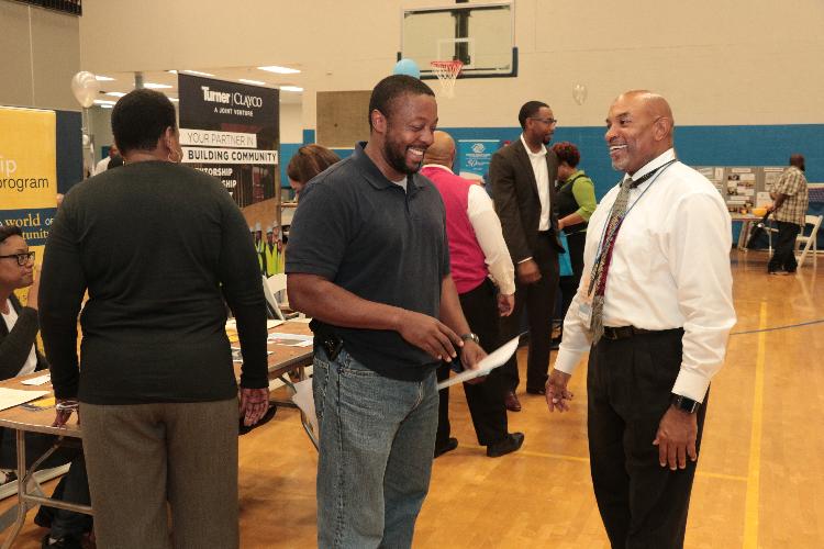 Slate Representative speaking with an attendee.