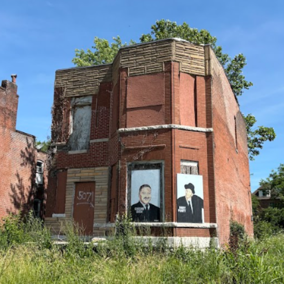 a two-story brick building with boarded-up windows
