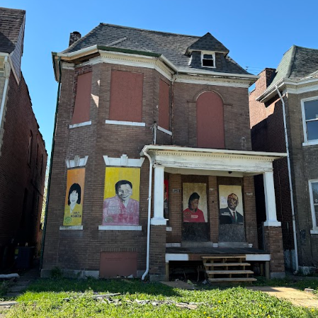 a two-story brick building with boarded-up windows