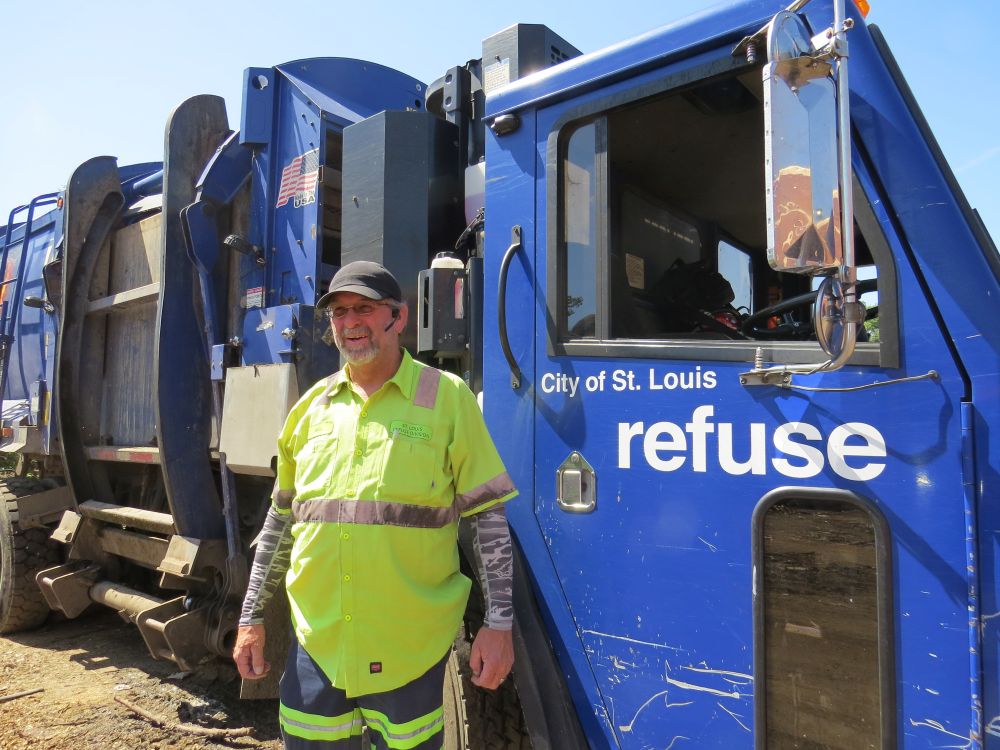 Refuse Division employee standing in front of trash truck