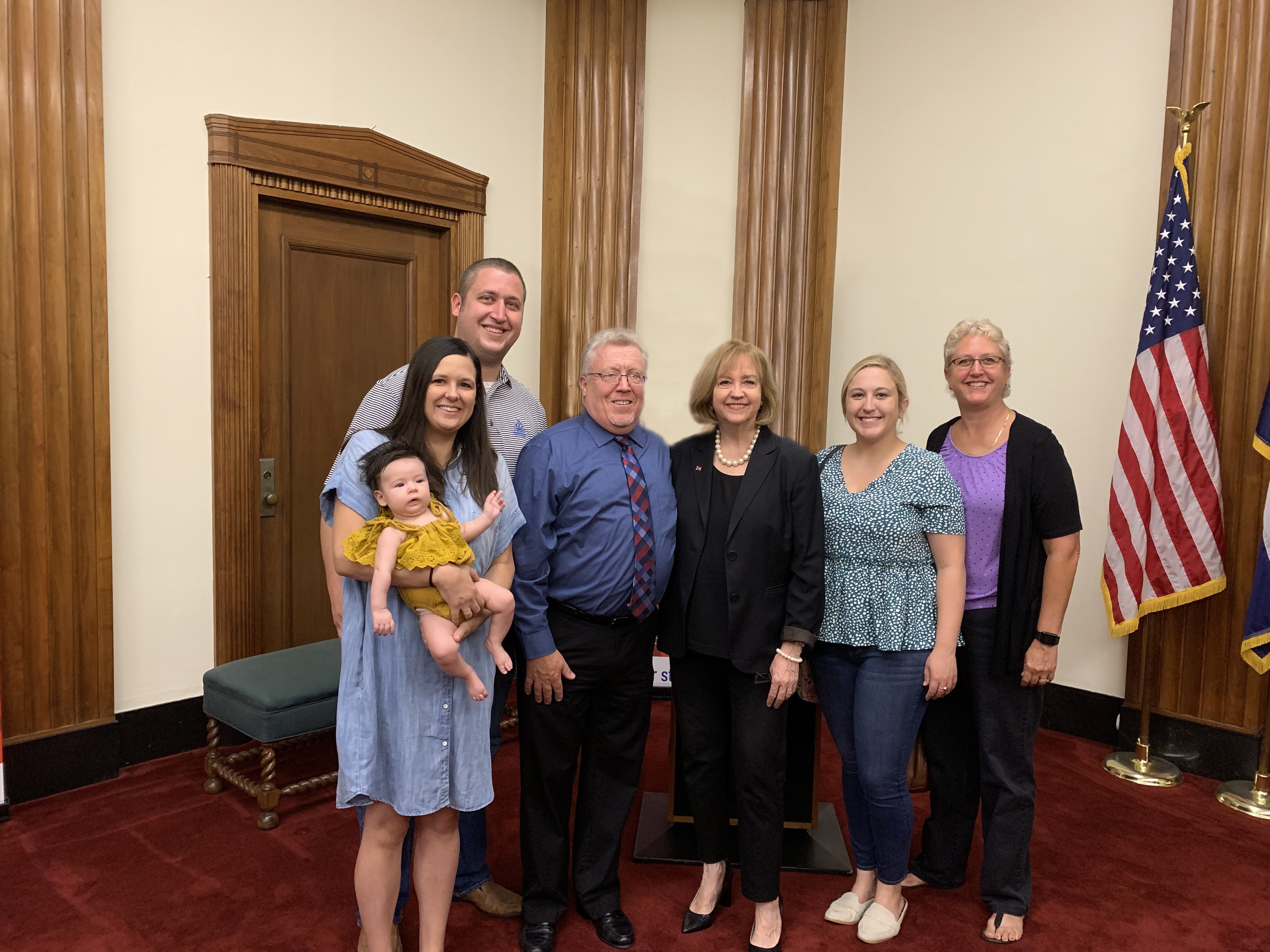 From left:  Jess Seemiller, holding granddaughter charlotte, Andy Seemiller, Mike Seemiller, Mayor Lyda Krewson, Jessie Seemiller and Linda Seemiller