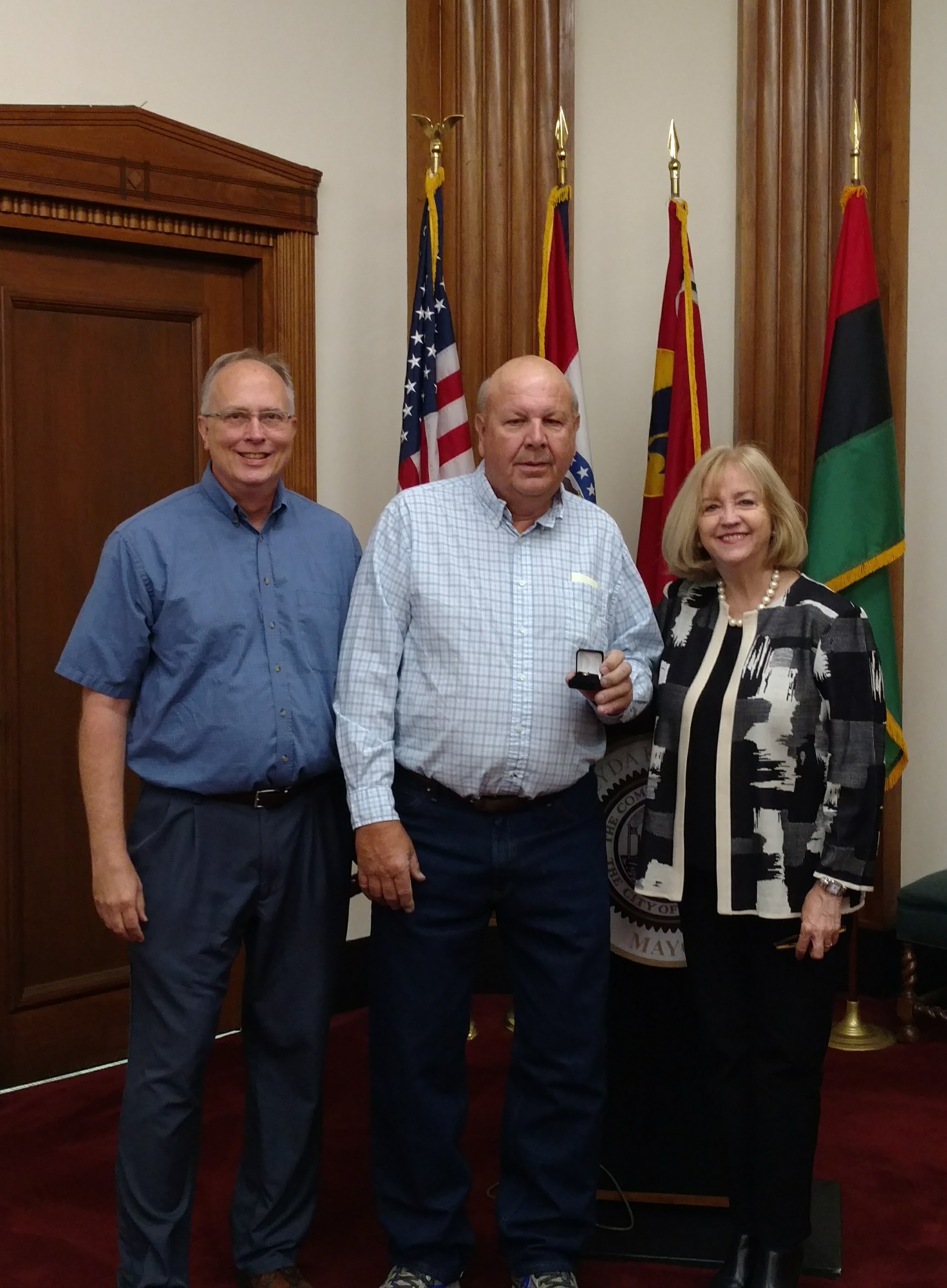 Public Utilities Director Curt Skouby (l) and Mayor Lyda Krewson congratulation Bill Jansen on his 40 years of service to the City of St. Louis.