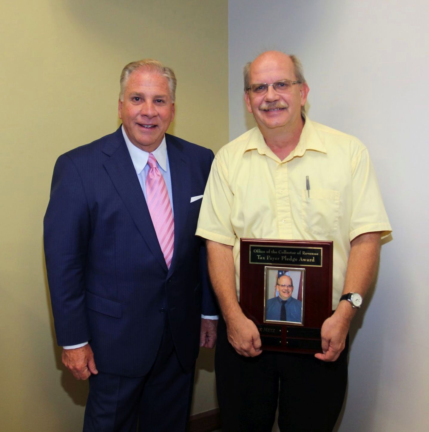 Collector of Revenue Gregory F.X. Daly presents Rick Metz with the Taxpayer Pledge Award