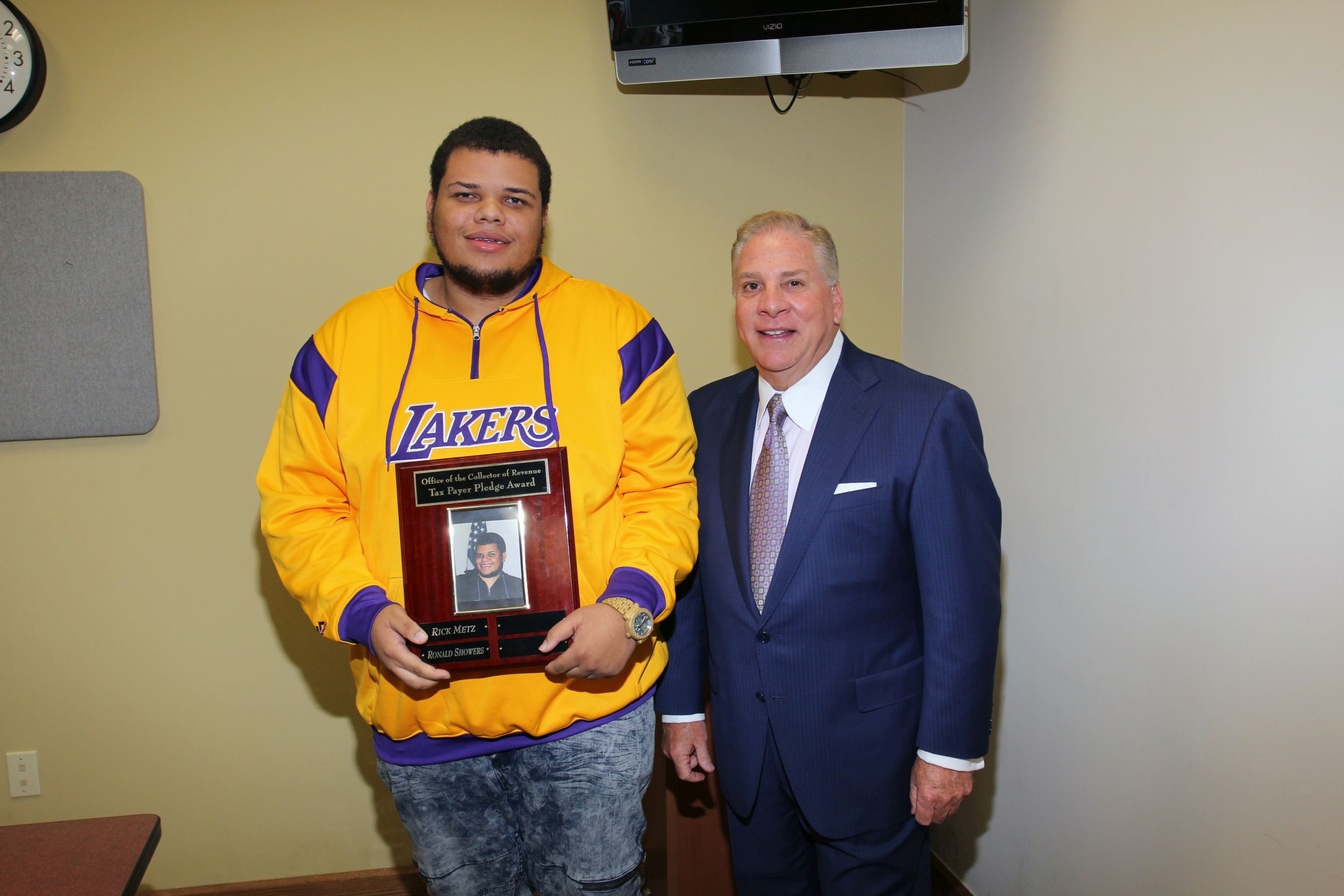 Collector of Revenue Gregory F.X. Daly presents award to Ronald Showers.