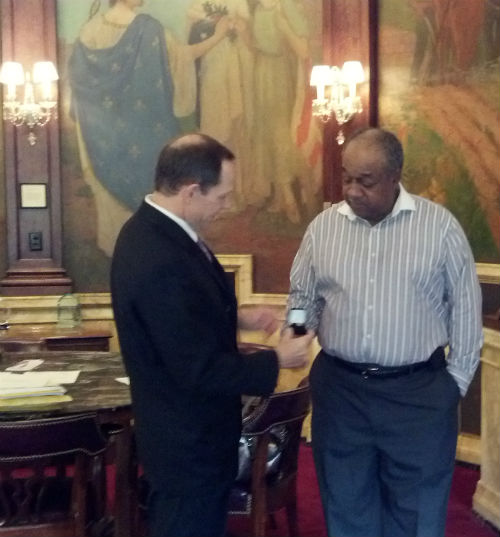 Mayor Slay presents the service pin to Robinson