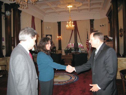 Mayor Francis G. Slay congratulates Claudia Roe as Ed Bushmeyer looks on.