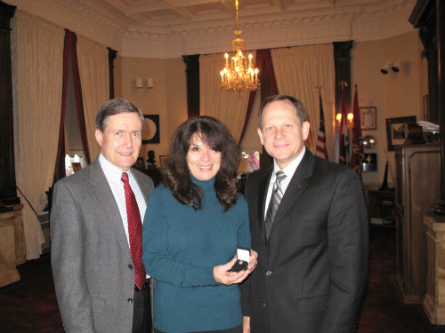 Claudia Roe receives 40-year service pin from Mayor Slay and Ed Bushmeyer