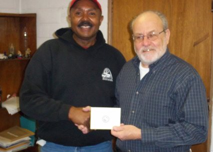 Johnnie Lee (l) receives his 40-year service pin from Refuse Commissioner Nick Yung
