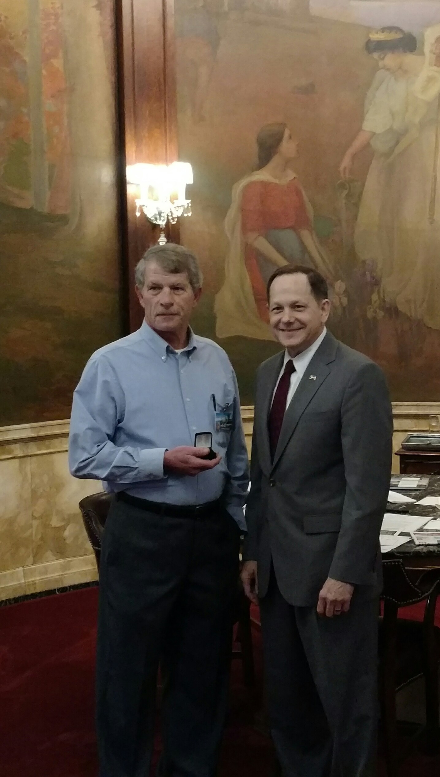 Mayor Francis Slay presents a 40-year service pin to Karl H. Meyer