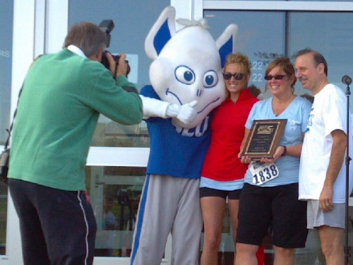 Photographer taking photo of The SLU Billiken, Caroline Ragsdale, Maureen Ragsdale and