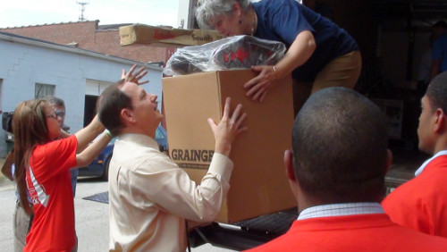 Mayor Francis G. Slay assists AmeriCorp and Lumiere Place team members with donations.