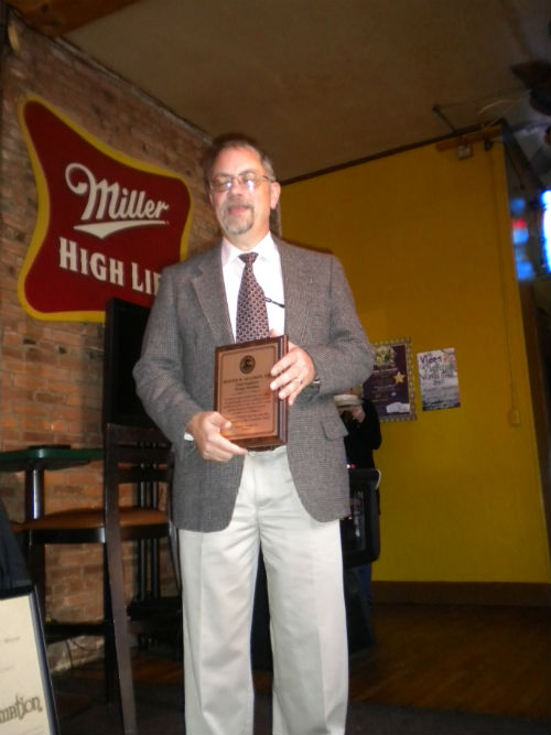 Roger Alision with is plaque from the Board of Public Service