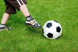 kid kicking soccer ball
