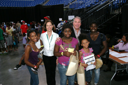 Collector of Revenue Gregory F.X. Daly and staffer Margaret McTague meet attendees at the Licensing / Resources / Back-to-School Fair at Chaifetz Arena.