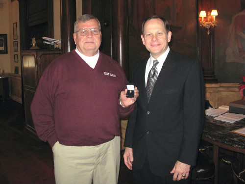 Mike Collins receives 40-year service pin from Mayor Francis G. Slay.