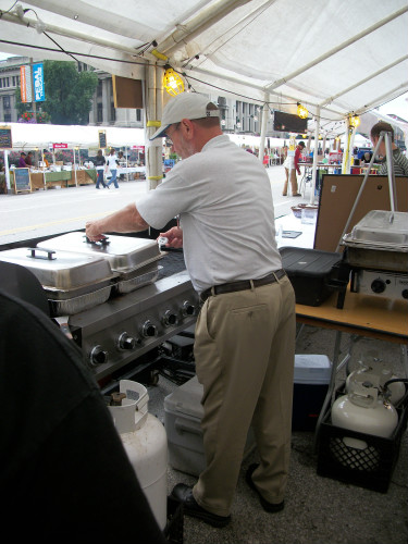 Jim Tucker inspects food at Taste of St. Louis